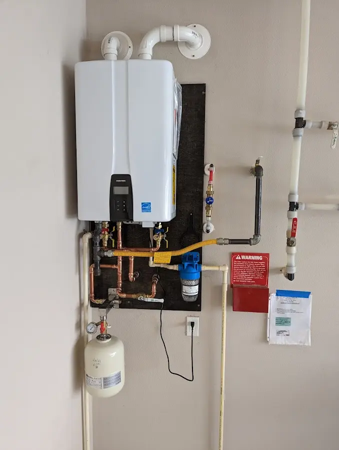 Professional plumber installing copper piping in a Cedar Lake home